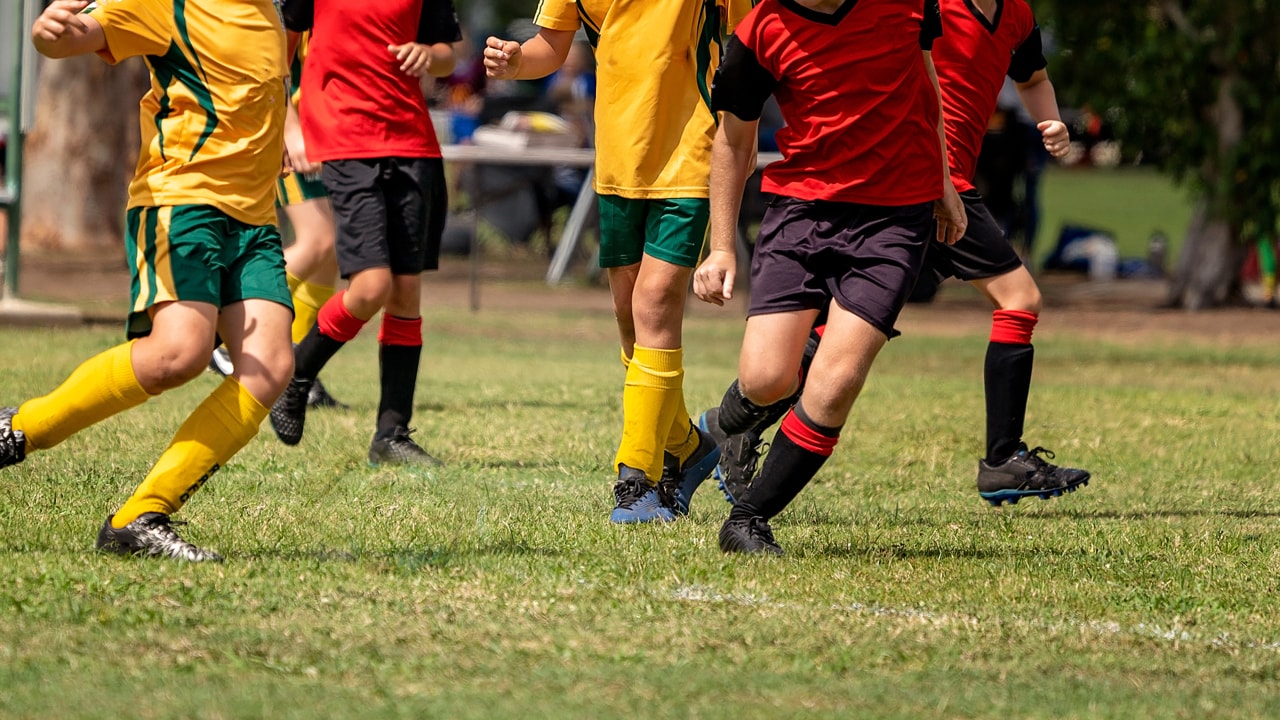 soccer players running on an oval