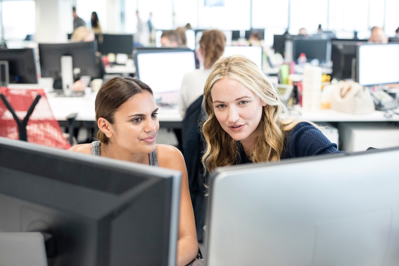 office workers looking at computer screens