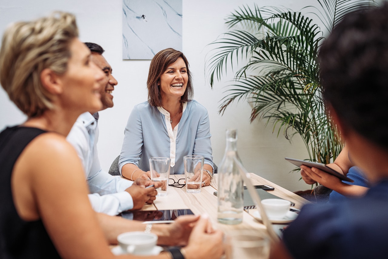 office work team laughing in a meeting